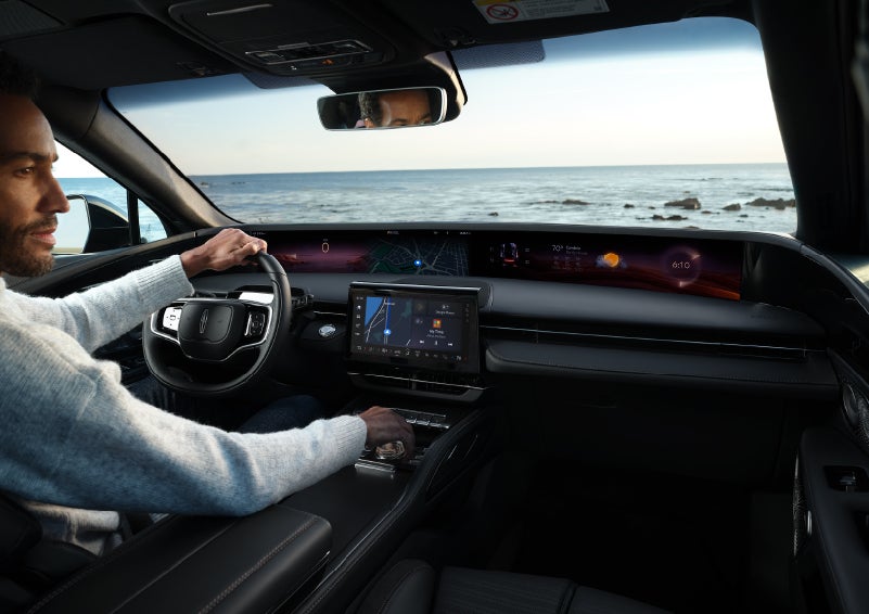 A driver of a parked 2024 Lincoln Nautilus® SUV takes a relaxing moment at a seaside overlook while inside his Nautilus. | Nick Mayer Lincoln Mayfield in Mayfield Heights OH