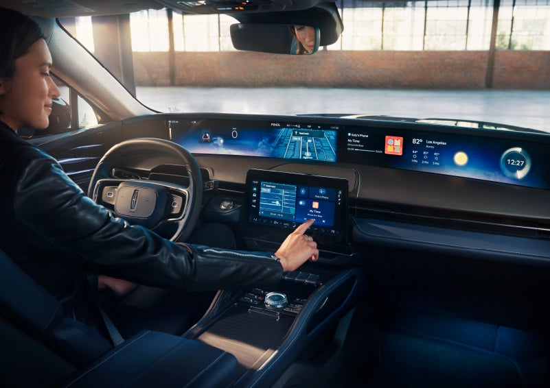 The driver of a 2024 Lincoln Nautilus® SUV interacts with the center touchscreen. | Nick Mayer Lincoln Mayfield in Mayfield Heights OH