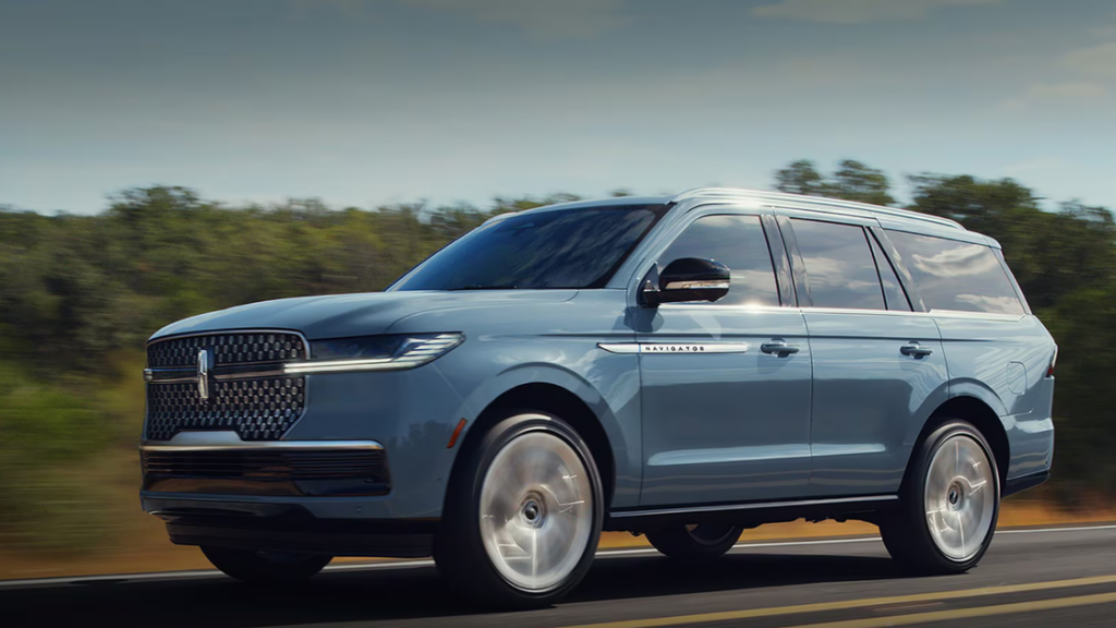 2025 Lincoln Navigator® Reserve blue exterior front three-quarter driving on highway.