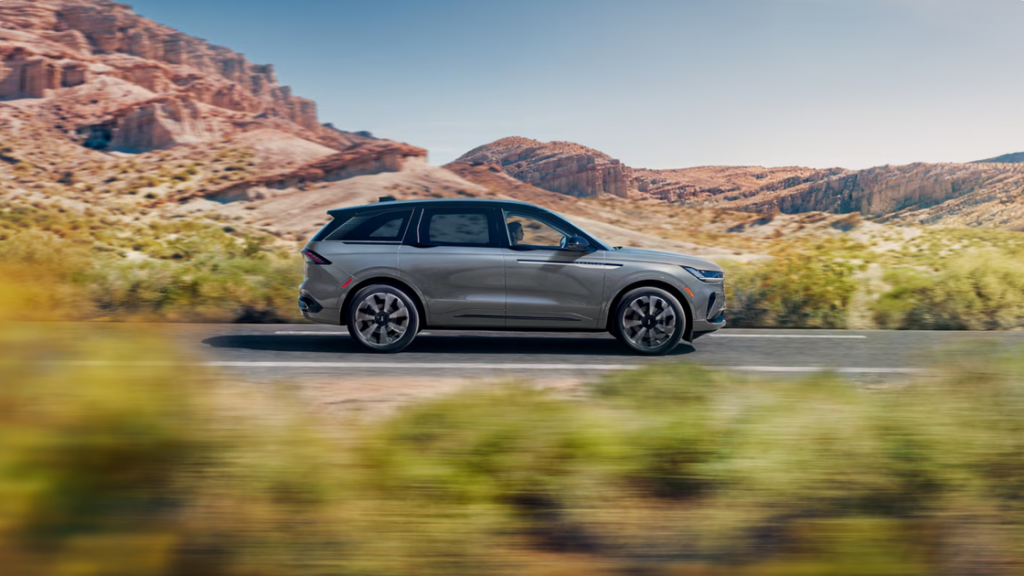 2026 Lincoln Nautilus® gray exterior side profile driving through canyon scenery.