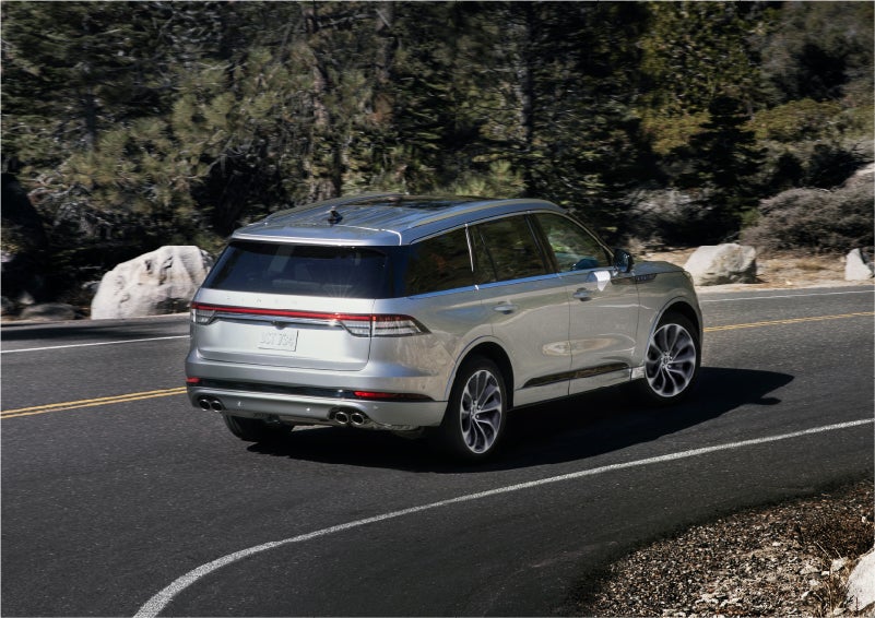 A 2023 Lincoln Aviator® Grand Touring model is shown being driven on a tight turn of a mountain road | Nick Mayer Lincoln Mayfield in Mayfield Heights OH