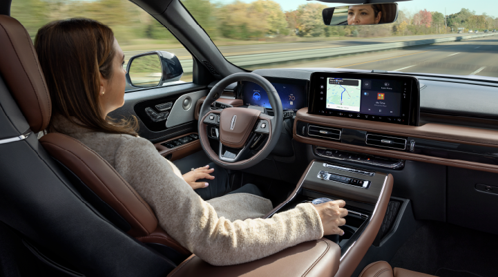 A woman is seen sitting in the driver’s seat of her 2025 Lincoln Aviator® SUV with her hands off the steering wheel. | Nick Mayer Lincoln Mayfield in Mayfield Heights OH