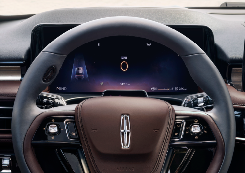 The steering wheel of 2025 Lincoln Aviator® SUV is shown with black and brown accents. | Nick Mayer Lincoln Mayfield in Mayfield Heights OH