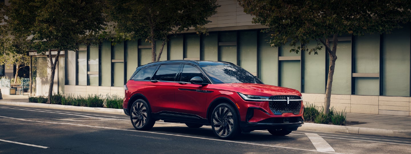 A 2025 Lincoln Nautilus® SUV with an available hybrid powertrain is parked in an urban setting. | Nick Mayer Lincoln Mayfield in Mayfield Heights OH