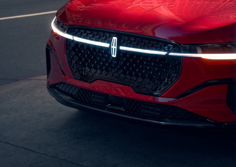 The available front LED light bar and center Lincoln Star logo glow at dusk. | Nick Mayer Lincoln Mayfield in Mayfield Heights OH