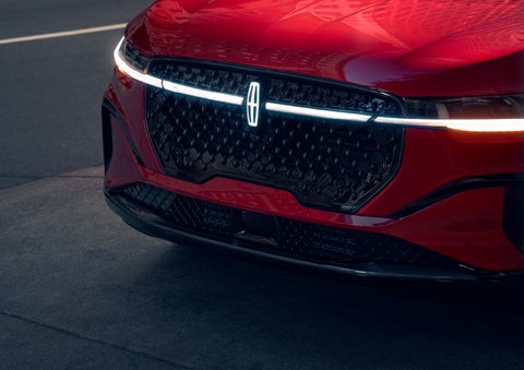 The available front LED light bar and center Lincoln Star logo glow at dusk. | Nick Mayer Lincoln Mayfield in Mayfield Heights OH