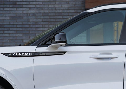 The driver’s side door and fender badging of a white 2026 Lincoln Aviator® SUV are showcased. | Nick Mayer Lincoln Mayfield in Mayfield Heights OH