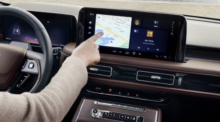A person is tapping the center display touchscreen of a 2026 Lincoln Aviator® SUV. | Nick Mayer Lincoln Mayfield in Mayfield Heights OH