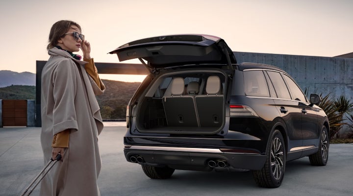 A woman approaches a 2026 Lincoln Aviator® SUV with its rear liftgate open. | Nick Mayer Lincoln Mayfield in Mayfield Heights OH