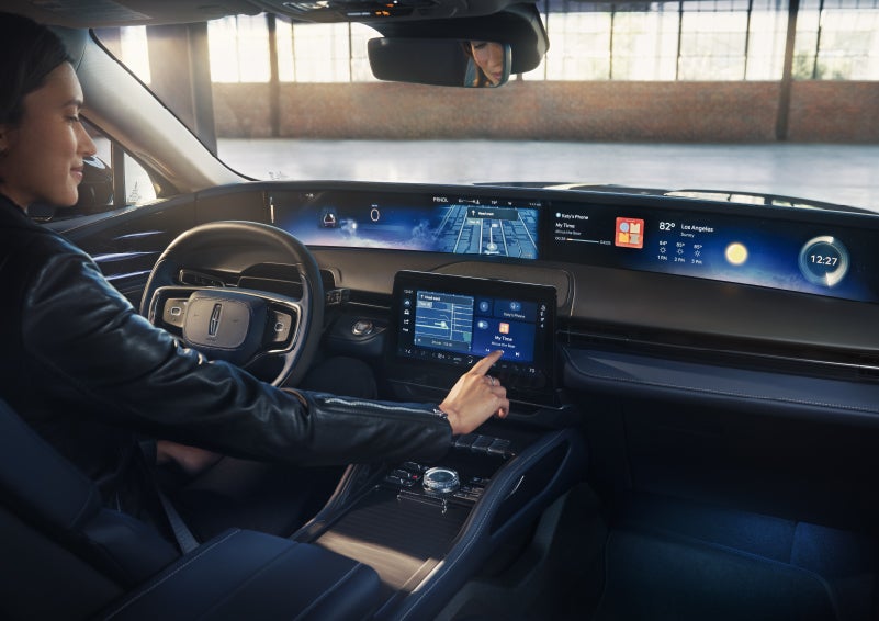 The driver of a 2026 Lincoln Nautilus® SUV interacts with the center touchscreen. | Nick Mayer Lincoln Mayfield in Mayfield Heights OH