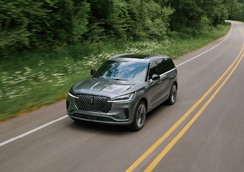 A 2027 Lincoln Aviator® SUV is being driven down a road. | Nick Mayer Lincoln Mayfield in Mayfield Heights OH