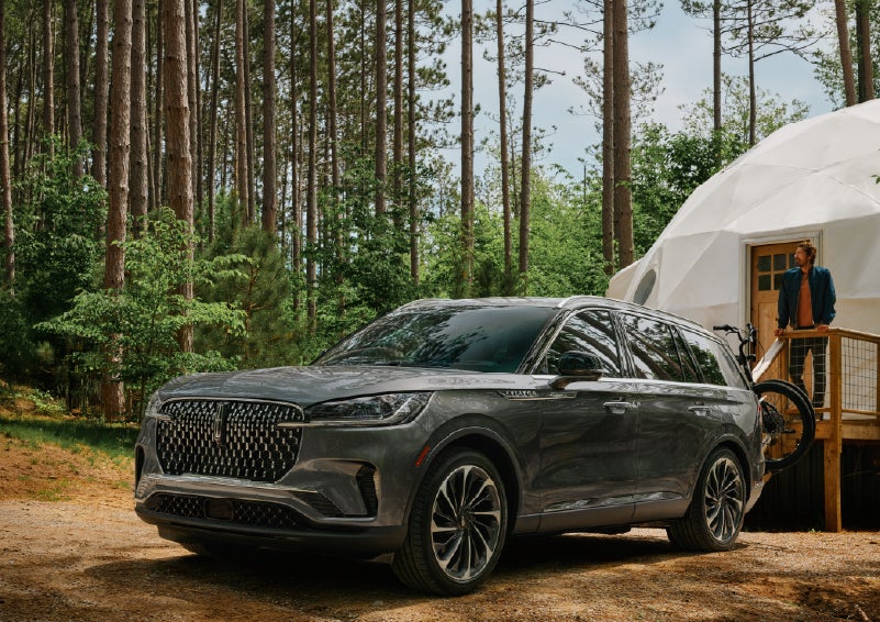 A 2027 Lincoln Aviator® is parked next to a high end glamping site. | Nick Mayer Lincoln Mayfield in Mayfield Heights OH
