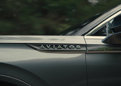 The driver’s side door and fender badging of a gray 2027 Lincoln Aviator® SUV are showcased. | Nick Mayer Lincoln Mayfield in Mayfield Heights OH
