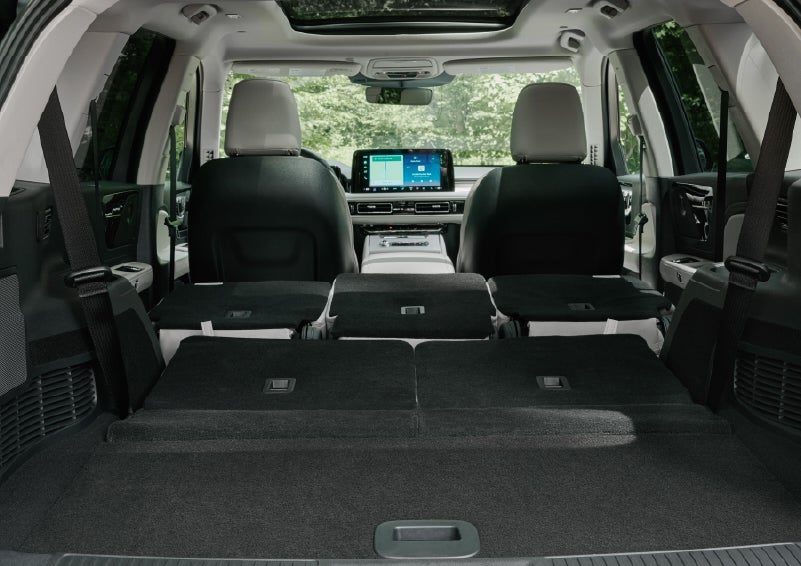 A rear to front view of the interior of a 2027 Lincoln Aviator® Black Label™ SUV shows the third and second rows folded flat | Nick Mayer Lincoln Mayfield in Mayfield Heights OH