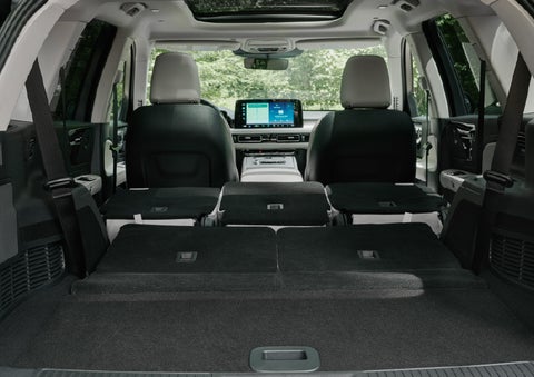 A rear to front view of the interior of a 2027 Lincoln Aviator® Black Label™ SUV shows the third and second rows folded flat | Nick Mayer Lincoln Mayfield in Mayfield Heights OH