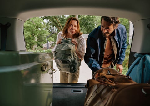 A couple loads luggage into the rear of a 2027 Lincoln Aviator® Black Label™ SUV..e 202 | Nick Mayer Lincoln Mayfield in Mayfield Heights OH