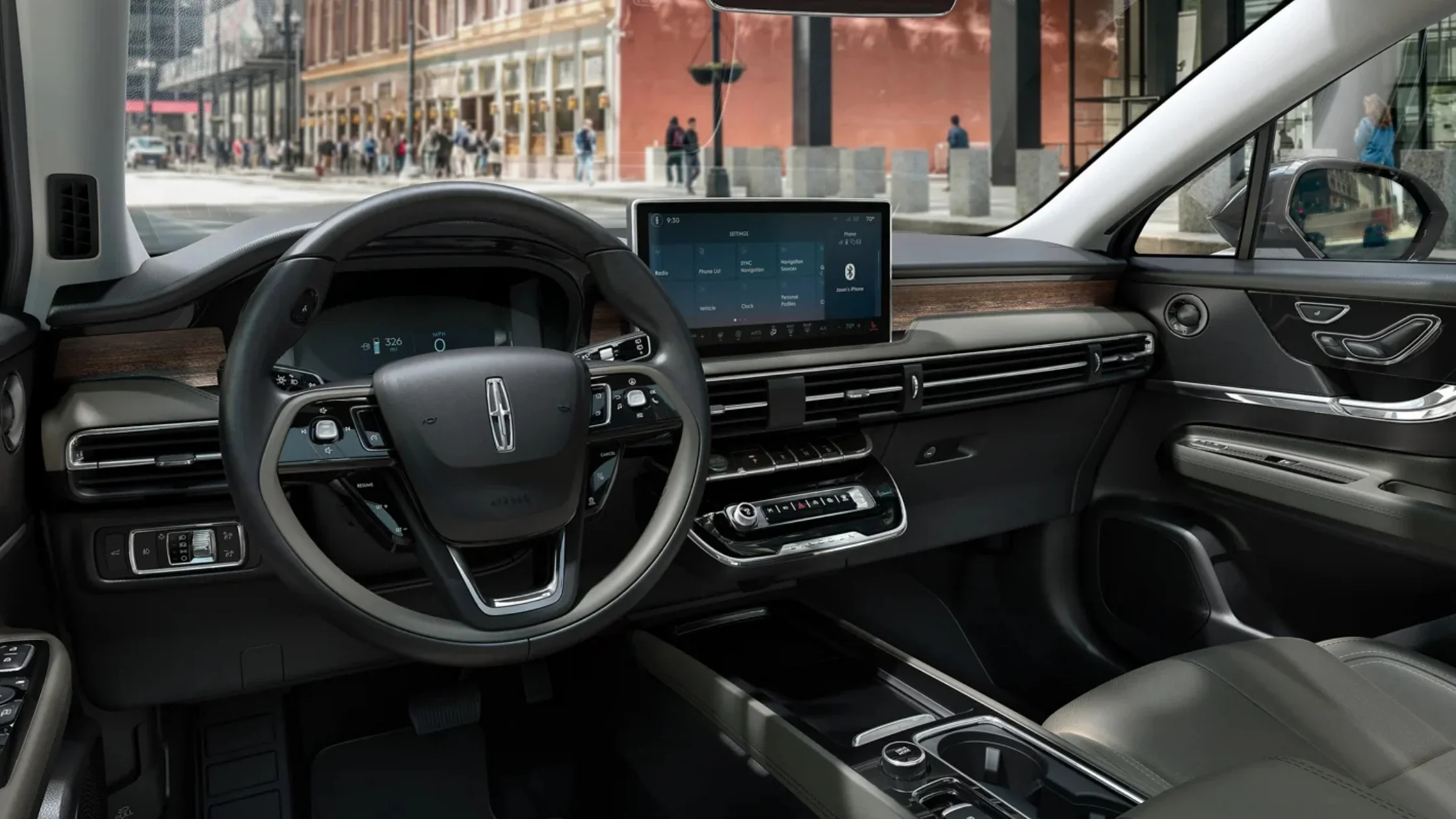 2025 Lincoln Corsair Reserve front interior featuring digital display, wood trim, and touchscreen infotainment.
