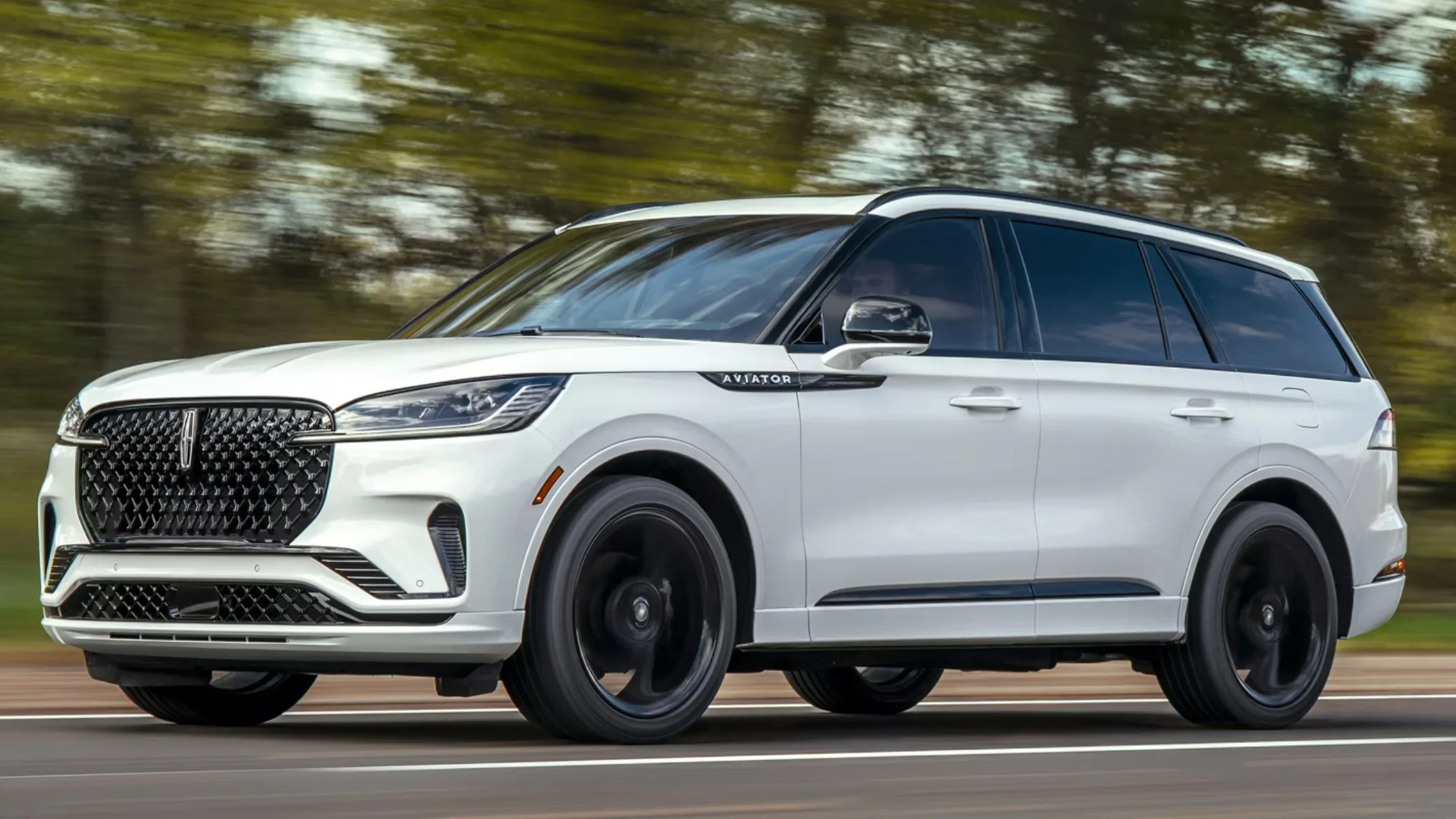 2025 Lincoln Aviator® Reserve in white, driving on a road.