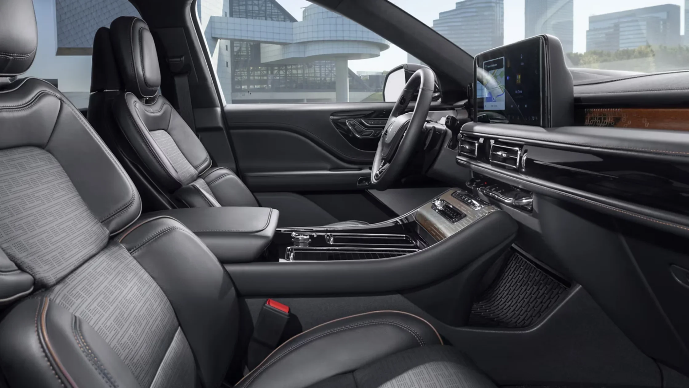 Interior view of the 2025 Lincoln Black Label Aviator®, showcasing premium black leather seats with patterned inserts.
