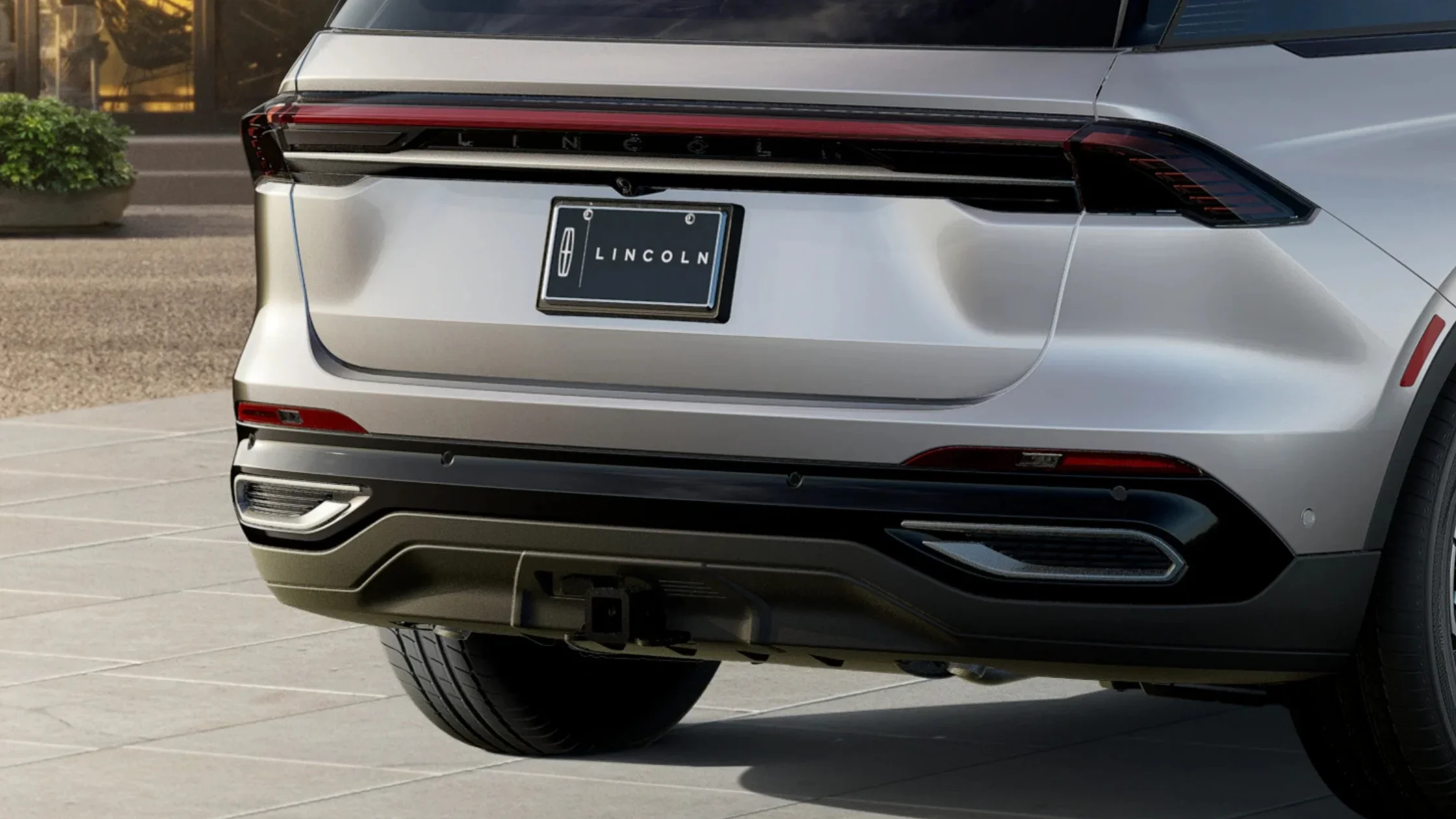 Rear view of a 2025 Lincoln Black Label Nautilus®, showcasing its sleek design, full-width LED taillights, and a "Black Label" badge on the rear license plate.