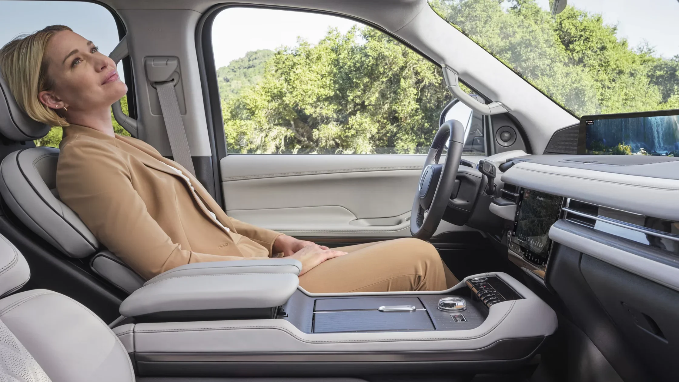 2024 Lincoln Navigator® front passenger seat reclined with woman relaxing inside luxurious cabin