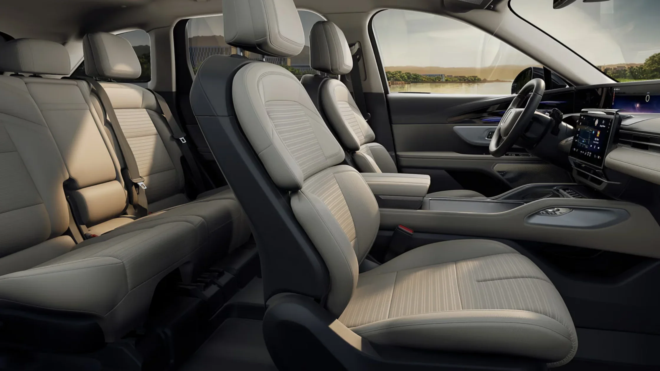 Side view of 2025 Nautilus® Reserve cabin showing three-row tan seats and digital dashboard