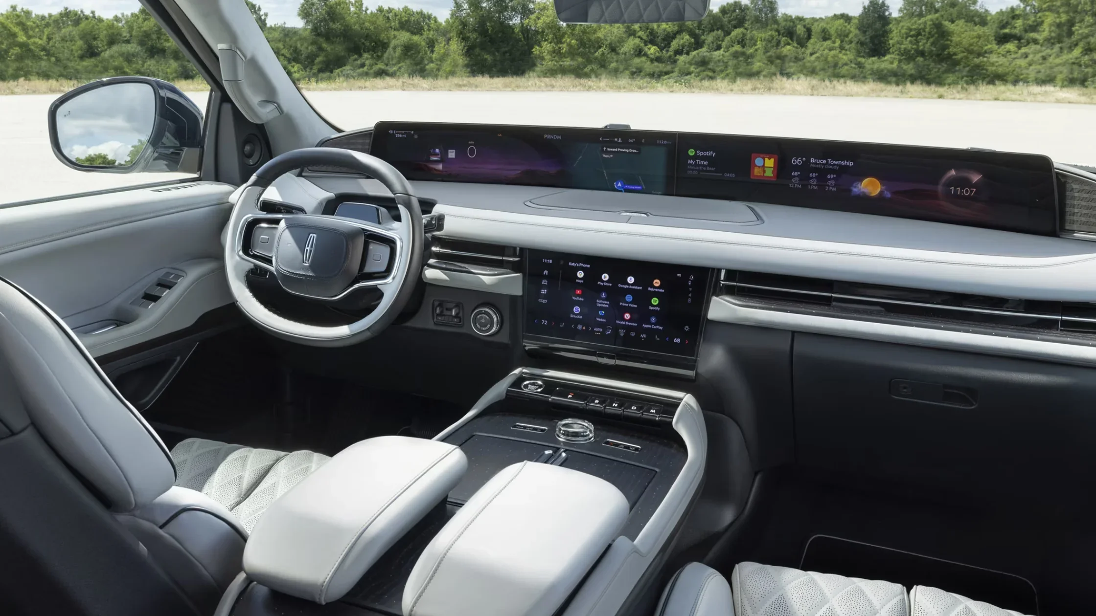 Center console of the 2025 Navigator® Reserve with rotary gear selector and sleek woodgrain finish.