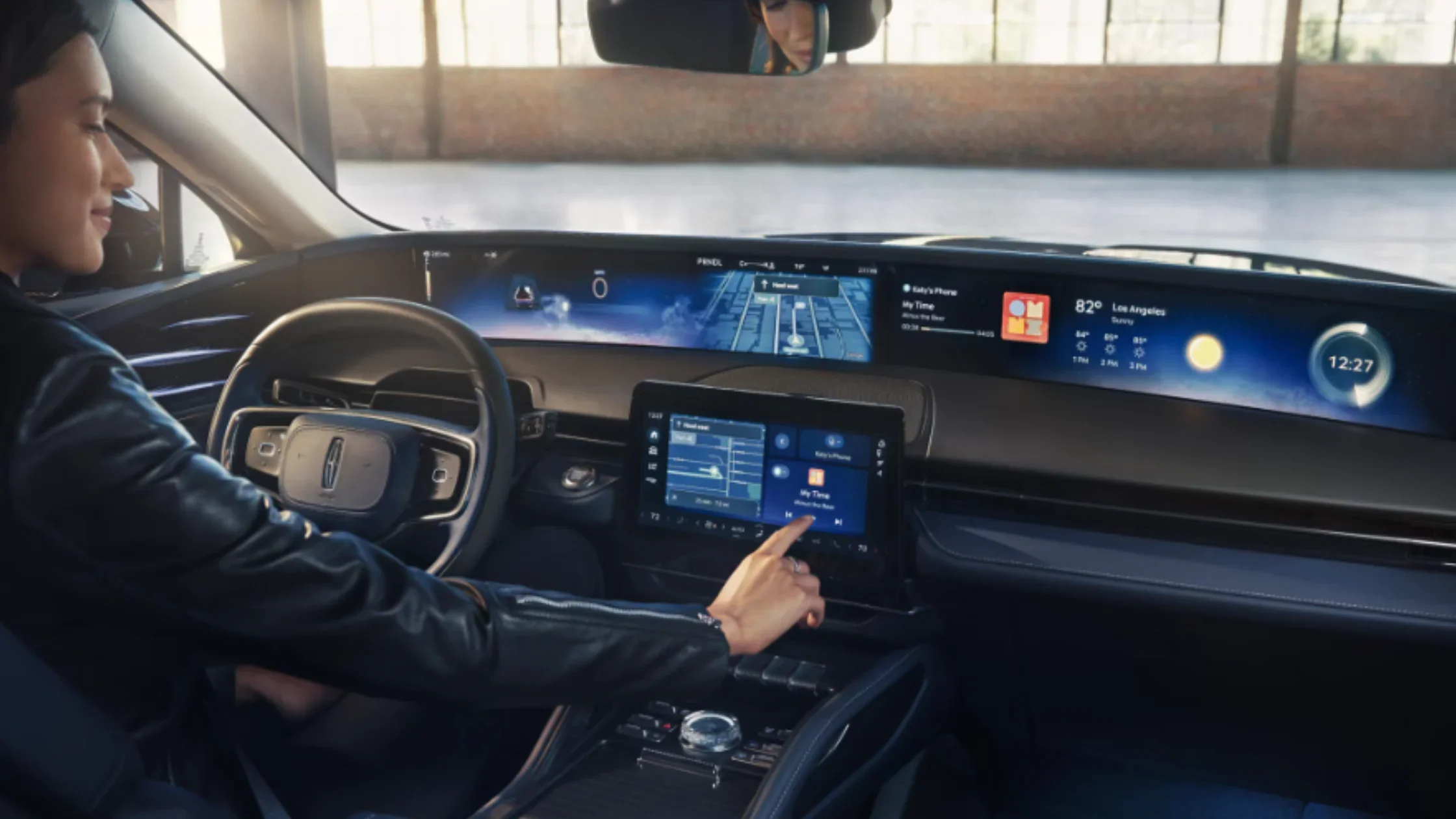 Driver operating the 2026 Nautilus® dual-screen digital cockpit featuring advanced navigation and multimedia controls.