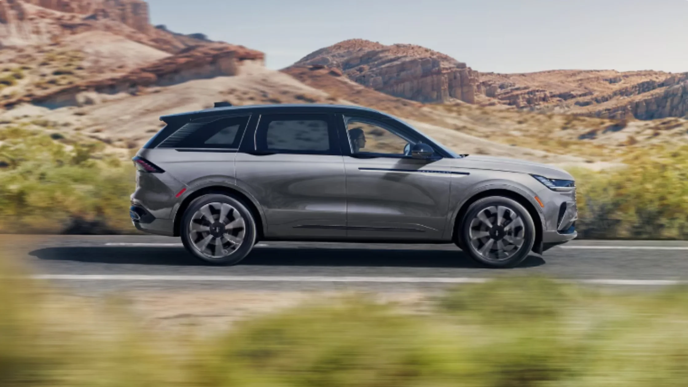 2026 Nautilus® luxury SUV in gray showcased at sunset, emphasizing its bold grille and LED headlights.
