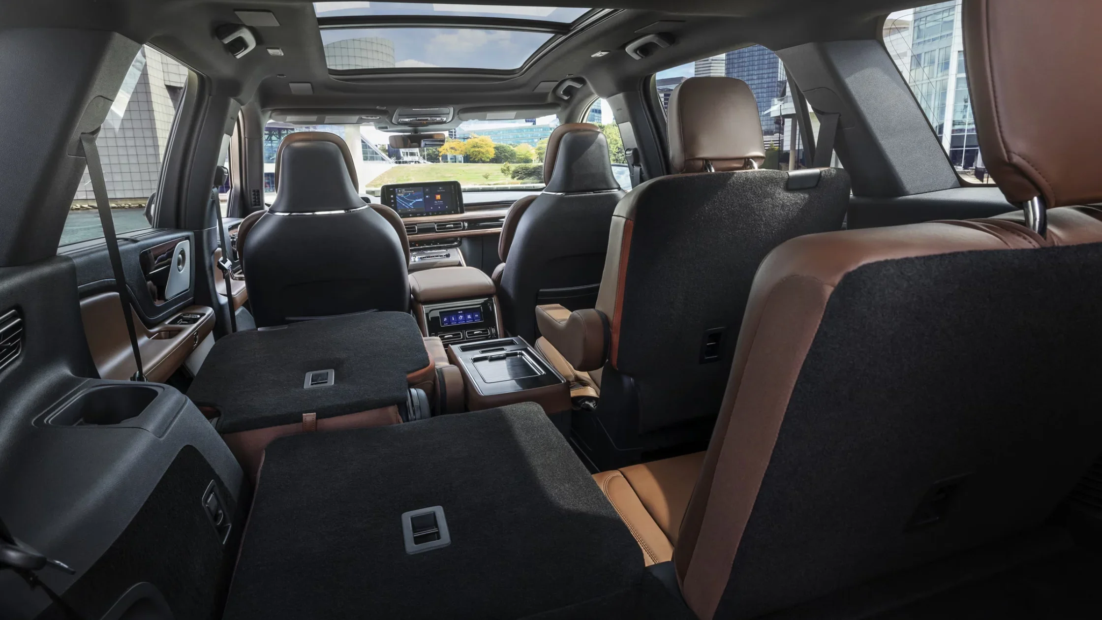 2025 Aviator® Reserve rear cabin view with folded seats and panoramic sunroof.